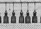 Bells II  From a temple in Bangkok.  These bells surround the temple on three sides and visitors will walk around the temple ringing each bell to bring luck. : BW, Thailand