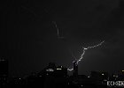 Electric  Lightning stricking a nearby sky scraper during a lightning storm one night in Bangkok. : Thailand